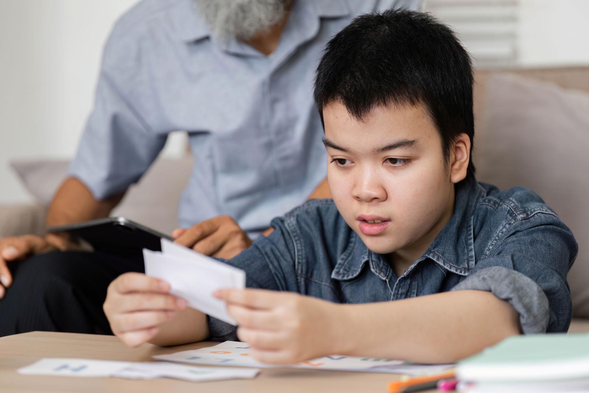A young family member looking closely at preserved family photographs