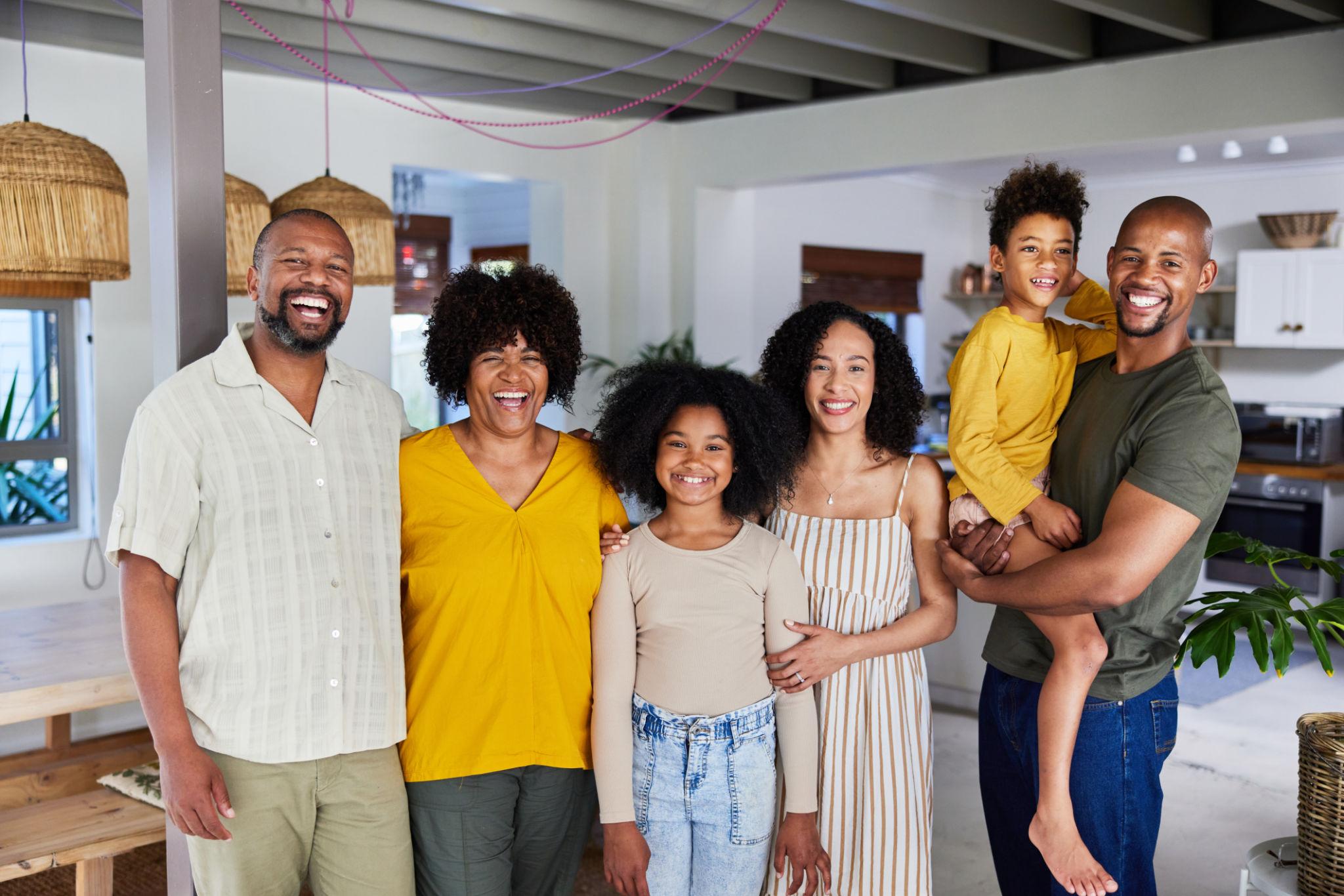 A smiling multigenerational family gathered together at home